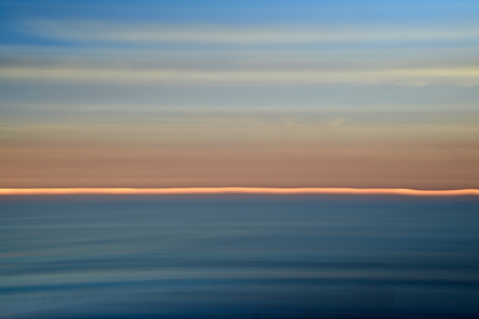 Minimal blue ocean abstraction with a glowing coral horizon
