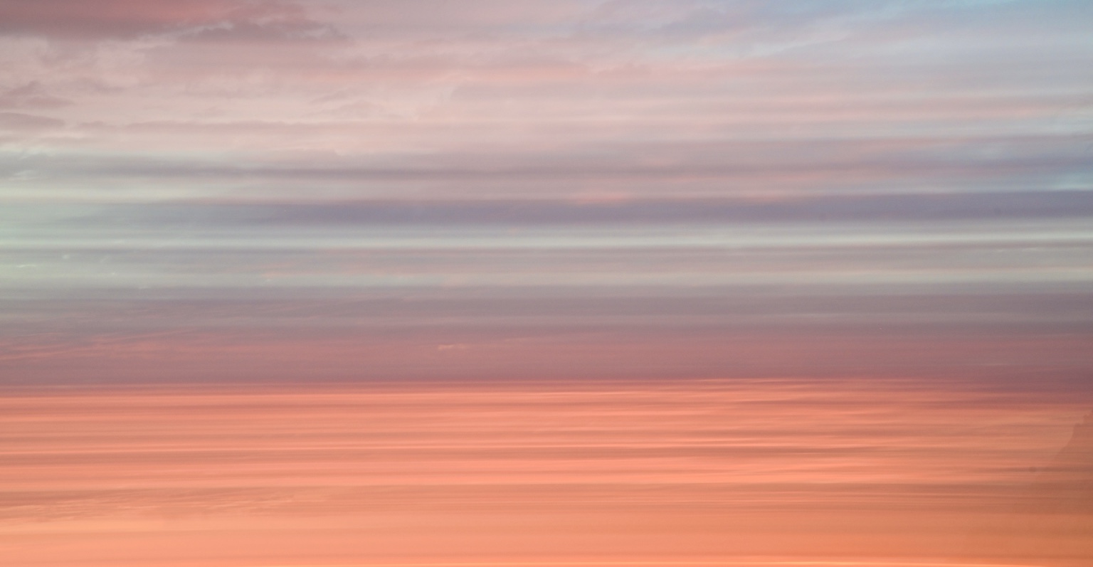 Soft pink and coral ocean abstraction beneath a pastel sky