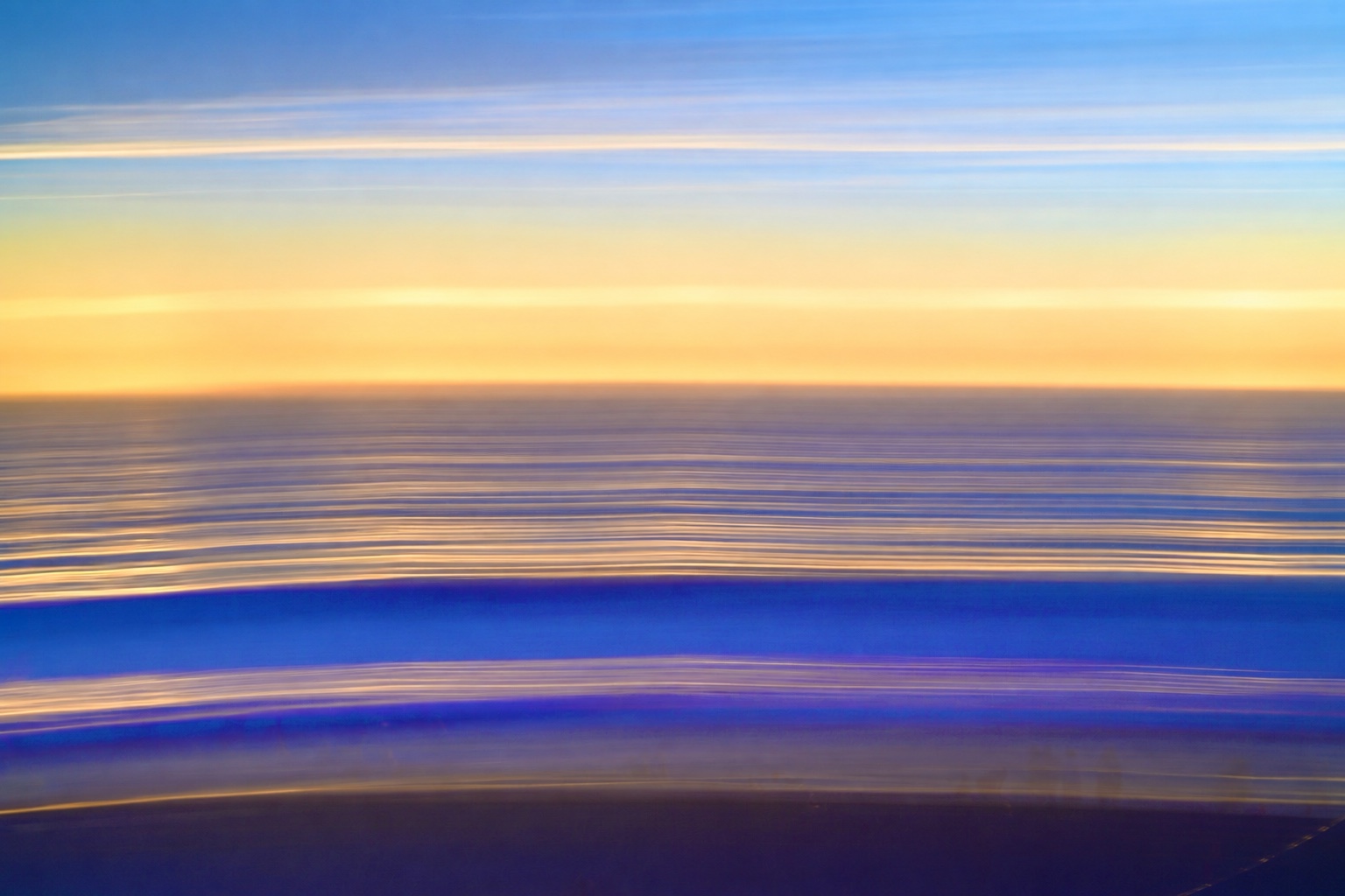 Ocean abstraction with a yellow horizon between blue bands